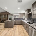 Beautiful cabinetry, designer tile backsplash, granite surfaces, recessed lighting, and generous workspace create a warm, inviting kitchen that's perfect for everyday living and hosting gatherings.