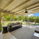 Enjoy outdoor living beneath the covered patio overlooking a spacious backyard with mature landscaping, making it an ideal setting for entertaining, dining, or simply relaxing in Glendale.