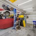 Exceptional garage space with approximately 20-foot ceilings offers endless possibilities for vehicle storage, restoration projects, workshop activities, or oversized equipment while maintaining outstanding organization.
