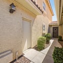 A private covered walkway welcomes you home with attractive landscaping, clean architectural lines, and easy access to the front entry, creating a warm and inviting arrival experience.