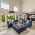 The spacious family room features impressive architectural details, abundant natural light, custom built-ins, and an open flow into the heart of the home, creating a comfortable gathering place for every occasion.