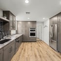 This impressive kitchen features custom alder cabinetry, granite countertops, stainless steel appliances, double ovens, induction cooking, and extensive storage designed for today's modern lifestyle.