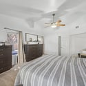 Featuring vaulted ceilings, soft carpeting, abundant natural light, and an open layout, this spacious bedroom creates a welcoming retreat with room to personalize your own private sanctuary.