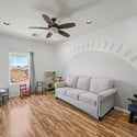 This generous upstairs living area offers endless possibilities as a media room, children's playroom, home office, or lounge, complete with updated flooring and ceiling fan.
