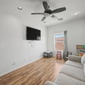 A bright and spacious flex room with wood-look flooring and modern finishes provides the perfect space for relaxing, entertaining, working from home, or family activities.