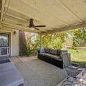 Relax beneath the covered patio complete with a ceiling fan and comfortable seating area overlooking the landscaped backyard. An inviting extension of the living space in this Glendale rental home.