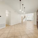 Spacious living areas with tile flooring and an open floor plan provide endless possibilities for relaxing, hosting guests, or creating personalized gathering spaces throughout this Glendale property.