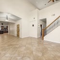 An airy floor plan with dramatic ceilings, elegant staircase, and seamless flow into the remodeled kitchen makes this Glendale home ideal for entertaining and comfortable daily living.