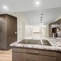 Premium granite countertops, an oversized island, induction cooktop, custom cabinetry, and stainless steel appliances create a stylish and highly functional kitchen for today's lifestyle.