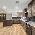 This beautifully renovated kitchen combines custom cabinetry, granite counters, designer backsplash, and generous prep space to create the perfect setting for cooking and entertaining.