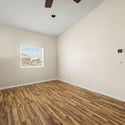 This oversized upstairs loft features updated flooring, ceiling fan, and an open layout that easily adapts as a home office, media room, fitness area, or additional family living space.