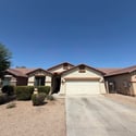 Well-maintained front exterior with attractive desert landscaping, attached two-car garage, and extended driveway. This Phoenix rental offers excellent curb appeal and easy outdoor maintenance.