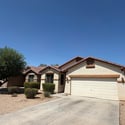 Inviting front entrance with an attached garage, spacious driveway, and attractive low-maintenance landscaping. Enjoy comfort and convenience at this Phoenix rental property.