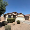 Attractive exterior featuring mature shrubs, clean architectural lines, and easy-care desert landscaping. This rental home offers lasting curb appeal in a convenient Phoenix location.