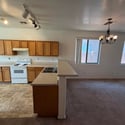 Open-concept kitchen with breakfast bar seating and a clear view of the spacious living area. Designed for convenience, comfort, and easy entertaining in this Phoenix rental.