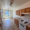 Functional kitchen featuring extensive cabinetry, generous countertops, and an inviting dining area with natural light. A practical layout for daily living and hosting guests.