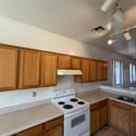 Well-designed kitchen offering abundant wood cabinetry, expansive counter space, and a practical workflow. The open floor plan enhances functionality and everyday comfort.
