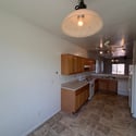 Bright dining area adjacent to the kitchen provides a welcoming place for everyday meals. Large windows bring in natural light while enhancing the home's open feel.