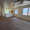 Open-concept great room with oversized windows, abundant natural light, and an easy flow into the kitchen. A welcoming space for gathering with family and friends.
