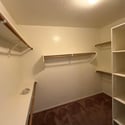 Expansive walk-in closet with built-in shelving, multiple hanging areas, and abundant storage to keep your wardrobe neatly organized in this Phoenix rental.