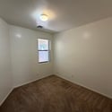 Versatile bonus room with plush carpeting and natural light, ideal for a home office, study, fitness room, or creative workspace.