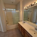 Bright full bathroom offering dual sinks, a tub and shower combination, and plenty of counter space for convenient daily routines.