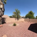 Large backyard featuring easy-care desert landscaping, mature trees, and a fully fenced layout that offers privacy and room to relax or entertain. A great outdoor feature of this Phoenix rental property.