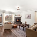 A welcoming living room is centered around a cozy gas fireplace.
