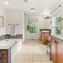 A five-piece primary bathroom is complete with dual vanities, a soaking tub, and separate shower.