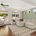 A spacious living room is accentuated by large windows, creating an atmosphere that feels both open and cozy.
