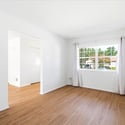 Spacious living area with natural light, featuring easy-maintenance flooring and fresh, neutral wall tones.