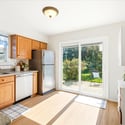 Bright kitchen featuring modern appliances, ample cabinetry, and direct access to a private outdoor space.