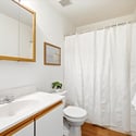 Well-maintained bathroom featuring a clean design with ample storage and natural light.
