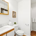 Bright and functional bathroom featuring modern fixtures, ample storage, and a warm, inviting atmosphere.