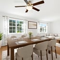 Bright and inviting dining area featuring large windows, modern furnishings, and a spacious layout perfect for gatherings.