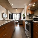 Modern kitchen featuring sleek cabinetry, stainless steel appliances, and an open layout with abundant natural light.