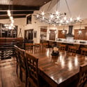 Spacious dining area featuring a striking chandelier, warm wood accents, and open layout perfect for gatherings.