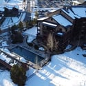 Trailhead lodge with outdoor pools, surrounded by stunning mountain views and convenient access to recreational activities.