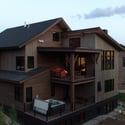 Modern mountain home featuring expansive outdoor spaces, a hot tub, and stunning views, perfect for relaxation. Back exterior.