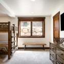 Bunk room with four queen beds, a TV, and a double sink en suite bath with shower/tub combo.