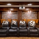 Discover a cozy home theater featuring comfortable seating, unique decor, and inviting niche seating.