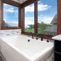 Enjoy breathtaking views from this luxurious freestanding bathtub, perfect for relaxation and tranquility.