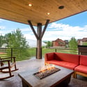 Spacious covered deck featuring Emerald Mountain views and a fire pit, perfect for outdoor relaxation and entertaining.
