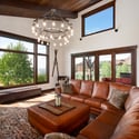 Spacious living area features large windows that showcase beautiful mountain views, offering an inviting atmosphere.