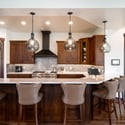 Modern kitchen featuring rich wood cabinetry, sleek countertops, and a spacious island perfect for gatherings.