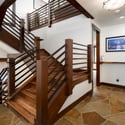 Inviting entryway featuring a blend of natural stone and warm wood accents, leading to multiple living spaces.