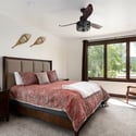 King bedroom featuring a ceiling fan, large windows with mountain views, an en-suite double sink bath with steam shower and private toilet room.