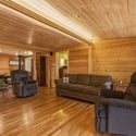 Spacious, warm living area features natural wood accents and comfortable seating for relaxed gatherings.