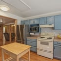 Bright and functional kitchen featuring modern appliances, laminate countertops, and seamless flow into the dining area.