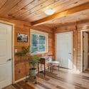 Cozy wooden interior with abundant natural light, perfect for a home office or quiet retreat.